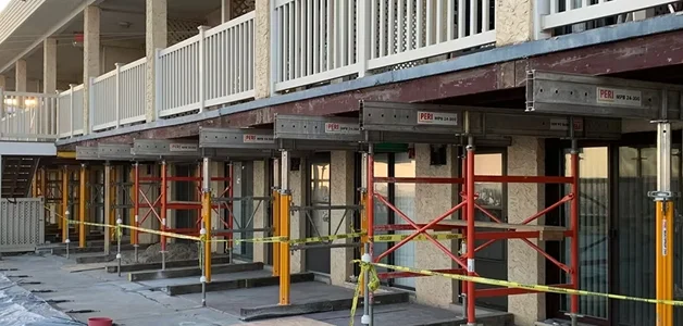 Construction scaffolding and supports under a building.