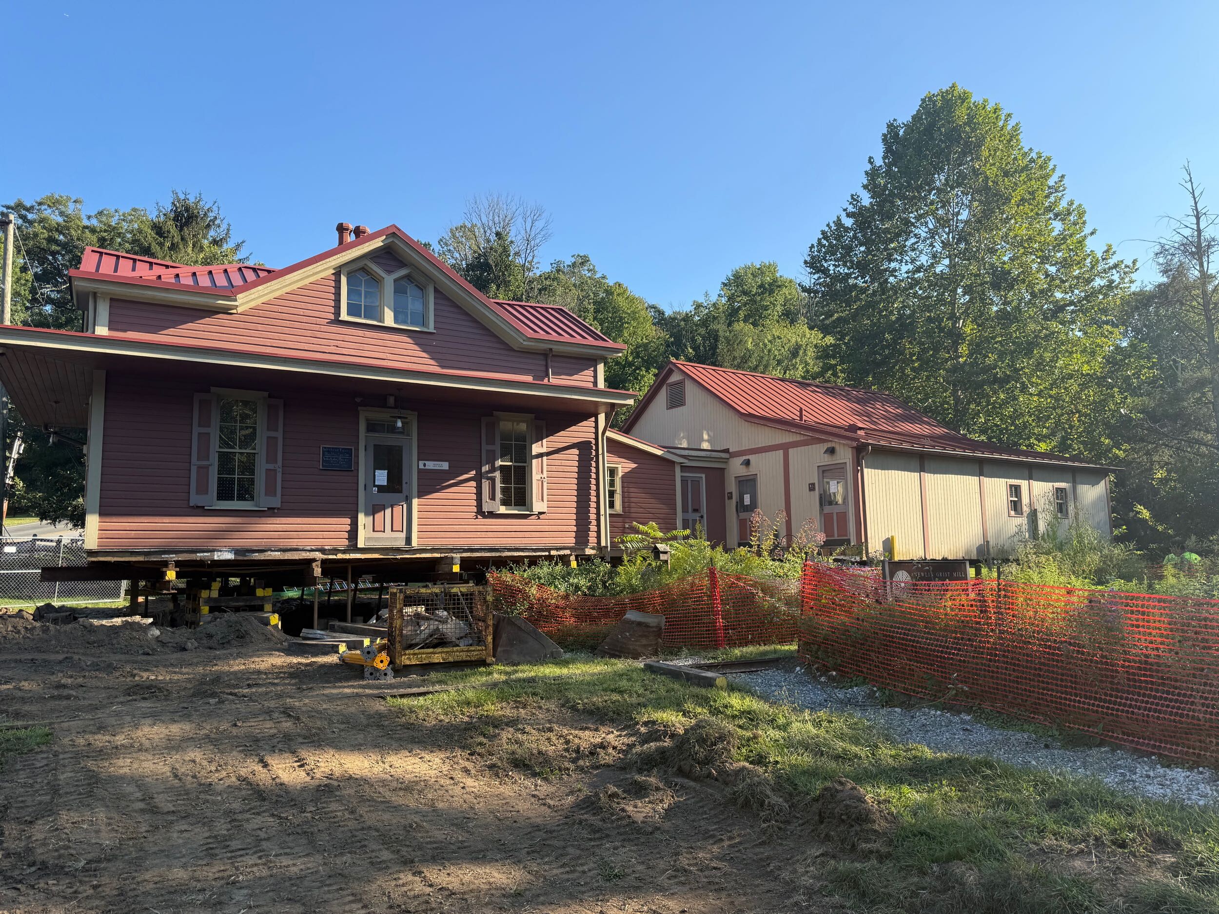 House propped up on tempopary structural jacks and wood beams